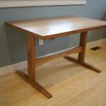 Solid elm base tresle table with bookmatched shopmade thick veneer top.