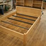 Hard Maple queen bed with satin black ledge and top.