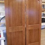 Cherry pocket doors with arch toned to match existing wood work.