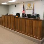 Stained quartersawn white oak legal bench with sections for judge, clerk and witness.  Black walnut rails.