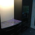 High gloss black bedroom set with backlit onyx counter surface.
