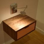 Bedside table with walnut case and copper faced drawer.