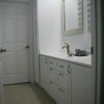 White painted vanity and linen cabinets, overlay.